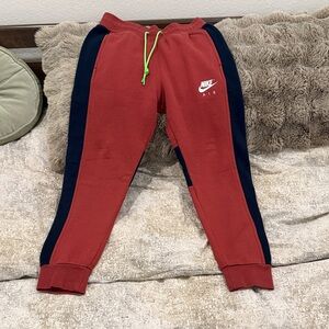 Nike Kids Red and Black Joggers with Green Accents
